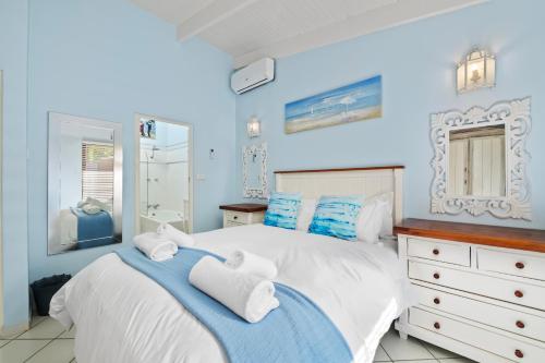 a blue bedroom with a bed with towels on it at San Lameer Villa 2845 - 3 Bedroom Classic - 6 pax - San Lameer Rental Agency in Southbroom