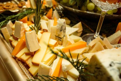 a plate of cheese and vegetables on a table at Aria by Brilliant in Zalău