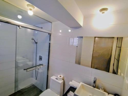 a bathroom with a shower and a toilet and a sink at Posada San Blas in Cusco