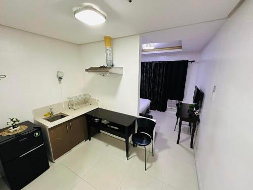 a kitchen with a sink and a table and chairs at hotel in ermita manila birch tower in Manila