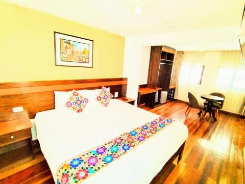 a hotel room with a bed and a desk at Posada San Blas in Cusco