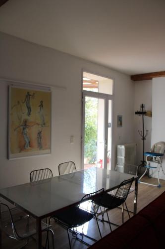 une salle à manger avec une table et des chaises dans l'établissement Maison chaleureuse avec grande terrasse, à Nîmes
