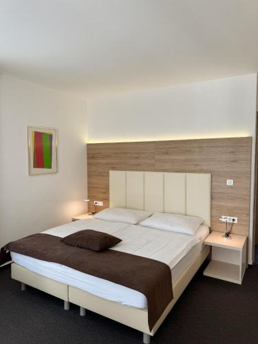 a bedroom with a large bed and two night stands at Hiša Aleš in Kranj