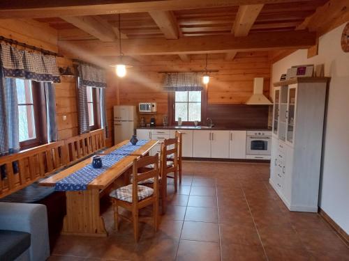 a kitchen with a long wooden table and chairs at CHALUPA ANNA in Dolní Morava
