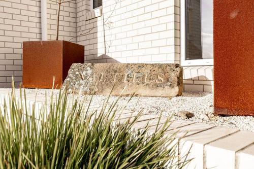 a stone bench in front of a building at Nautilus ~ Bay of Fires in Binalong Bay
