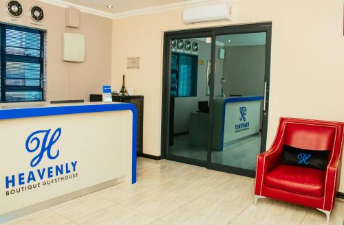 a red chair sitting next to a reception desk at Heavenly Boutique Hotel in Johannesburg