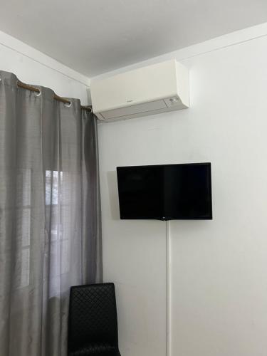 a room with a flat screen tv on the wall at Sun Place Guest House in Lagos