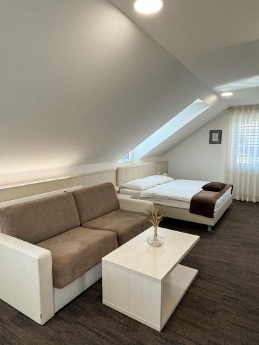 a living room with a couch and a bed at Hiša Aleš in Kranj