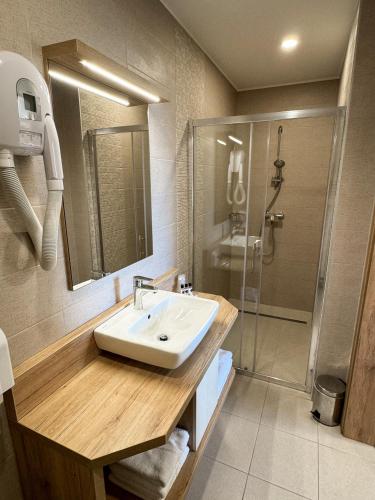 a bathroom with a sink and a shower at Hiša Aleš in Kranj