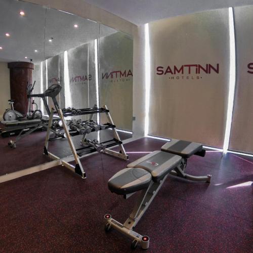 a gym with two treadmills and two machines at Samtinn Hotel King Fahad in Riyadh
