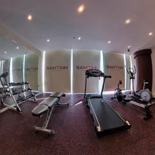 a gym with several treadmills and elliptical machines at Samtinn Hotel King Fahad in Riyadh
