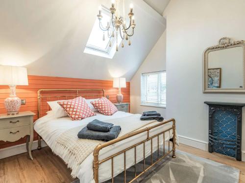 a bedroom with a bed and a chandelier at 2 Bed in Llangollen 86799 in Llangollen