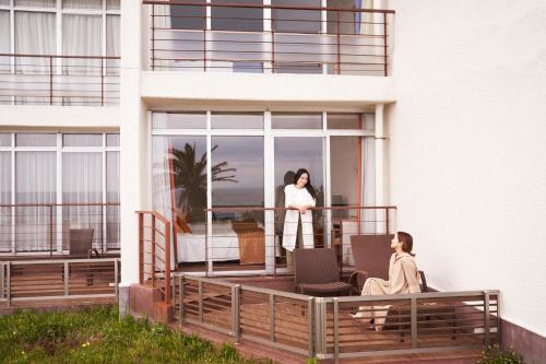 two women standing on the balcony of a building at Shimoda Prince Hotel in Shimoda