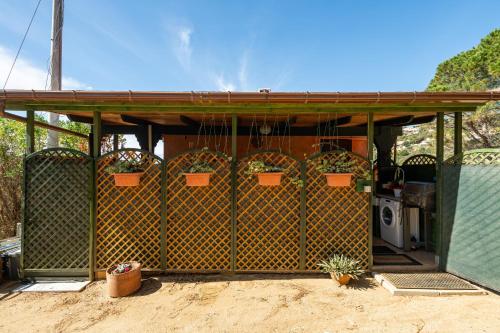 a gazebo with potted plants on it at Is Zuddas in Geremèas
