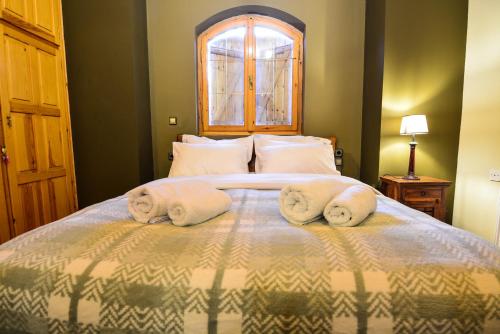 a bedroom with a bed with towels on it at Capris Rustic Ηouse with Mountain View in Archaia Feneos