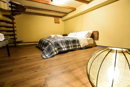 a bedroom with a bed and a lamp in it at Capris Rustic Ηouse with Mountain View in Archaia Feneos