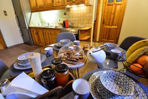 a table with plates of food on it in a kitchen at Capris Rustic Ηouse with Mountain View in Archaia Feneos