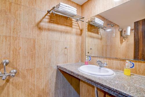 a bathroom with a sink and a mirror at Raj Palace Near City Cetre 2 Taj Hotel in kolkata