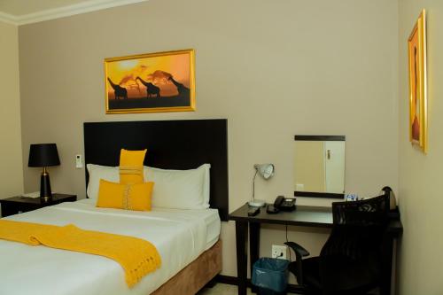 a bedroom with a bed and a desk with a mirror at Heavenly Boutique Hotel in Johannesburg