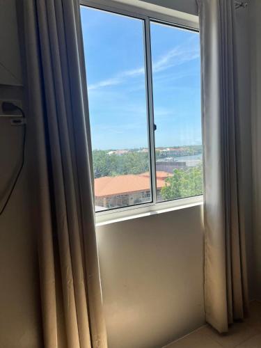 a window in a room with a view at Sunsets and Good Vibes - 2 Bedroom Condo Unit in Iloilo City
