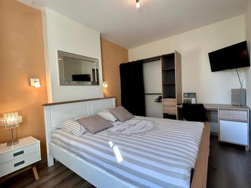 une chambre avec un lit et un bureau dans l'établissement Résidence Investar appartement 4 Superbe T2 meublé, Gare 10mn à pied, à Montluçon