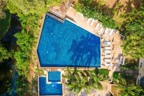 an overhead view of a large swimming pool at Comsaed River Kwai Resort in Kanchanaburi