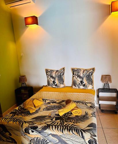 sypialnia z łóżkiem z 2 lampami w obiekcie appart T1 avec varangue vue mer et piscine ST GILLES LES BAINS w mieście Saint-Gilles les Bains