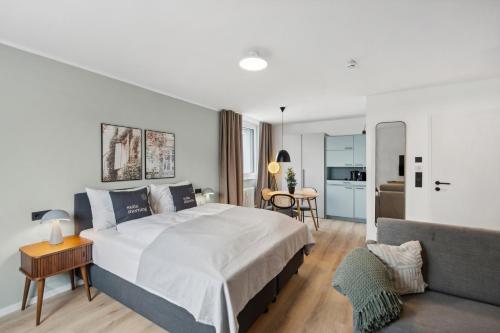 - une chambre avec un grand lit et un salon dans l'établissement limehome Salzburg Sterneckstr., à Salzbourg