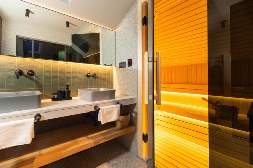 a bathroom with two sinks and a mirror at Majestic Villa Lidija by Irundo in Dubrovnik
