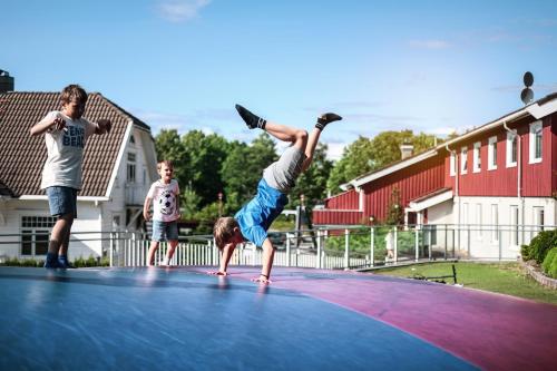 a young boy doing a handstand on a trampoline at Kristiansand Feriesenter in Kristiansand