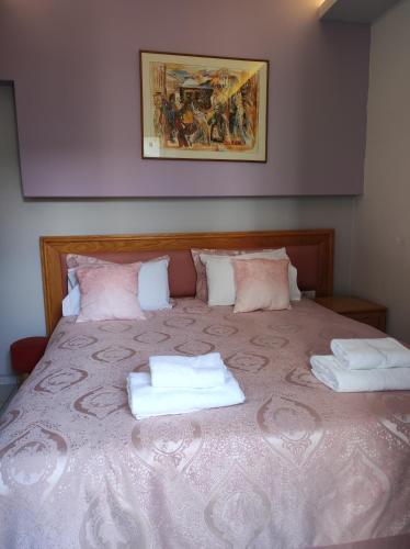 a bedroom with a bed with two towels on it at N E P center Hotel Rodos in Rhodes Town