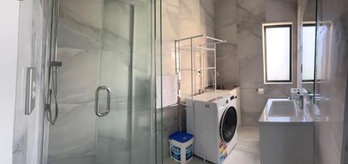 a bathroom with a shower and a sink at Relax by the Tamaki River in Auckland