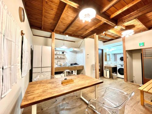 a kitchen with a table and chairs in a room at 木庵 "Moku-an"Tiny house go to Kyoto Nara in 1 hour in Osaka
