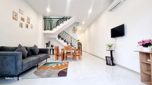 a living room with a couch and a table at Ngoc Anh' s House in Phu Quoc
