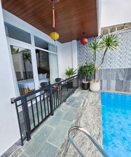 a balcony with a swimming pool in a house at White House Central Villa in Hoi An