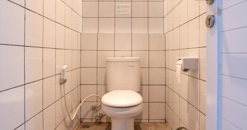 a bathroom with a white toilet in a stall at Bobopod Thamrin, Jakarta in Jakarta