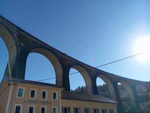 a bridge with three arches on top of a building at Chez Ana à Morez in Morbier