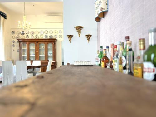 a bar in a room with bottles of wine at Villa Liberty TownHouse in Siena