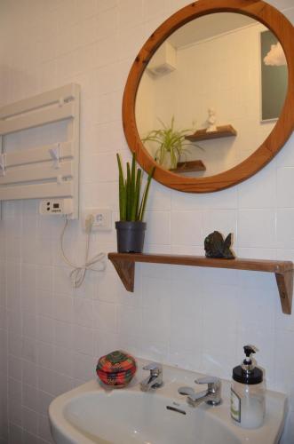 a bathroom with a sink and a mirror at Casa Aurora in Teo