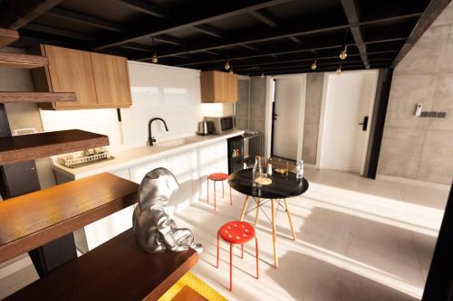 a kitchen with a table and red chairs in it at NSMA - The Loft experience in Riyadh