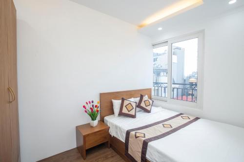 1 Schlafzimmer mit 2 Betten und einem Fenster in der Unterkunft Sumitomo 6 Apartment _ No 12 lane 523 Kim Ma street in Hanoi