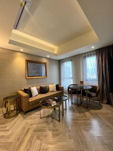 a living room with a couch and two tables at Wanda Vista Istanbul in Istanbul