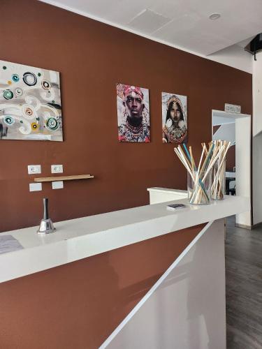 a counter in a room with paintings on the wall at Hotel apartments Crisvan in Bellaria-Igea Marina