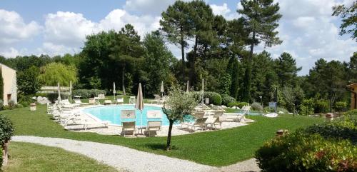 a pool with chaise lounge chairs and a swimming pool at Apartments Borgo Toscano in Gambassi Terme