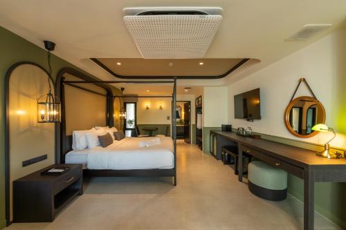 a bedroom with a bed and a desk with a mirror at Shamrock Chiangmai Hotel in Chiang Mai