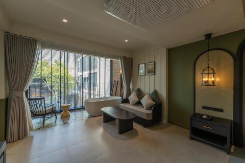 a bathroom with a bath tub and a large window at Shamrock Chiangmai Hotel-Adult Only in Chiang Mai