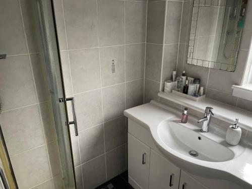 a bathroom with a sink and a mirror at Kilmarnock in Kilmarnock