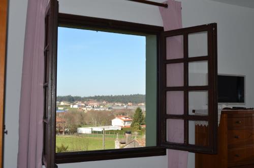 an open window with a view of a town at Casa Aurora in Teo
