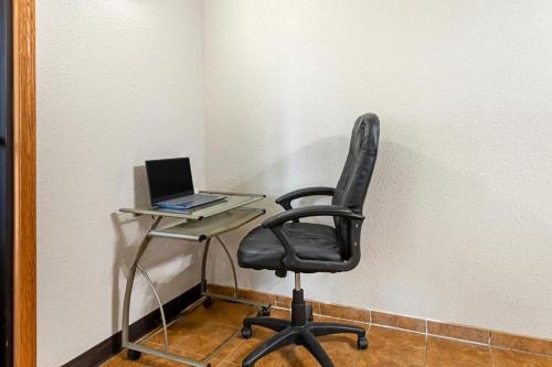 a desk with a chair and a laptop computer at Quality Inn in Bemidji