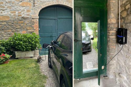 a car parked in front of a green garage at B&B CorteBonomini entire home in Sasso